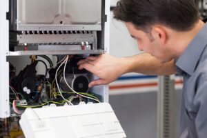 Furnace Repair 2 Technician repairing a boiler, adjusting internal components and wiring for optimal performance and safety. furnace repair