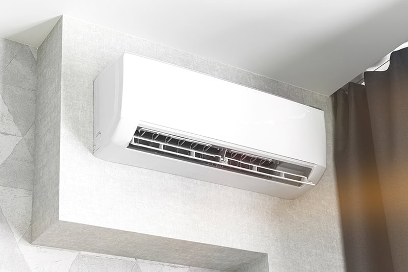 Air conditioner system on white wall living room interior.