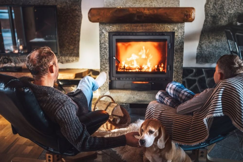 Cozy scene with family by the fireplace, relaxing with a dog. Warmth and comfort at home during winter.